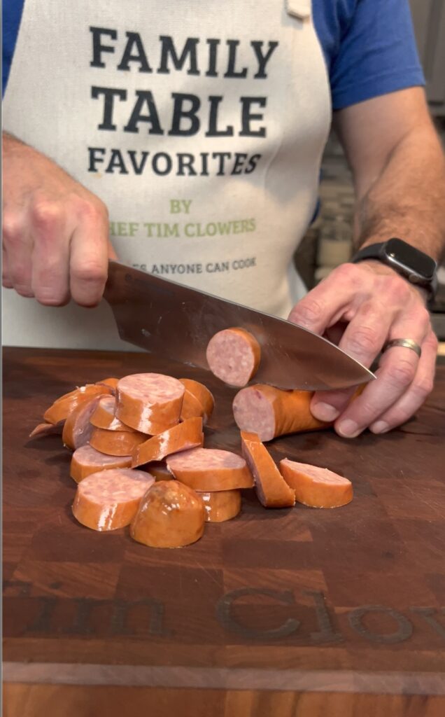 Slicing sausage for cooking.